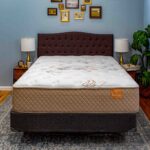 Lifestyle image of the Evermore mattress with beige border and decorated quilt.